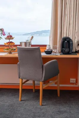 a chair sitting in front of a window at Thorbjørnrud Hotell in Jevnaker