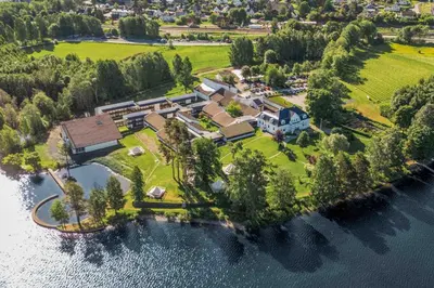 an aerial view of a house on an island in the water at Thorbjørnrud Hotell in Jevnaker