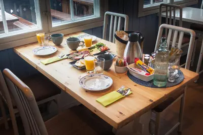 a wooden table with food and drinks on it at Storestølen Fjellhotell in Hovet