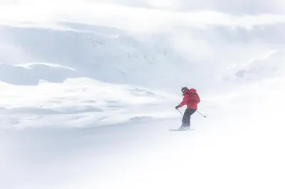 a man is skiing down a snow covered slope at Storestølen Fjellhotell in Hovet