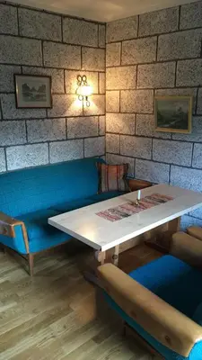 a table and chairs in a room with a brick wall at Voss Lodge Rongastovo in Vossevangen