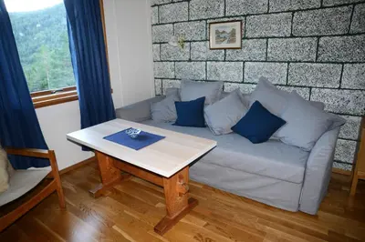 a living room with a couch and a table at Voss Lodge Rongastovo in Vossevangen