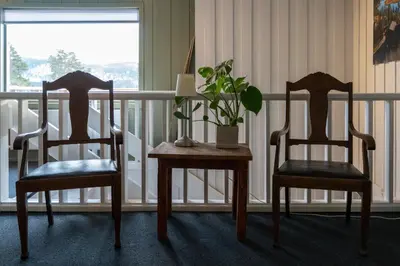 two chairs and a table with a plant on it at Austbø Hotell in Rauland