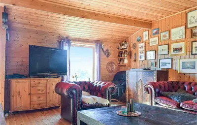 a living room with couches and a flat screen tv at Stunning Home In Haulandshella in Tveitevåg