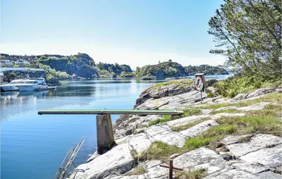 a table sitting on the side of a river at Stunning Home In Haulandshella in Tveitevåg