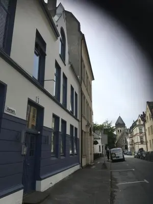 a blue and white building on the side of a street at Ålesund downtown loft room with shared bathroom in Ålesund