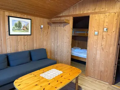 a room with a couch and a table and a bunk bed at Lyngmo Hytter in Hafslo