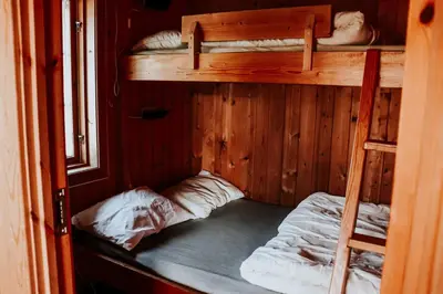 a room with two bunk beds and a ladder at Lyngmo Hytter in Hafslo