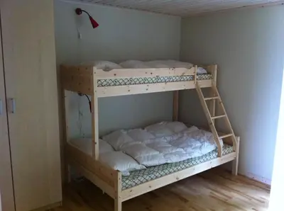 a wooden bunk bed in a corner of a room at Totakbu in Rauland