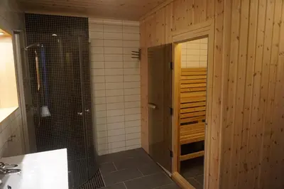 a bathroom with a shower and a glass door at Totakbu in Rauland