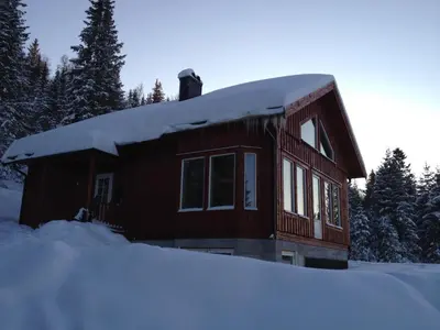 a log cabin with snow on the roof at Totakbu in Rauland