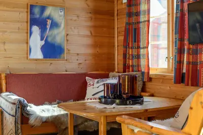 a living room with a table and a couch at Nordseter Hytter in Nordseter