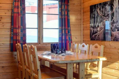 a dining room with a wooden table and chairs at Nordseter Hytter in Nordseter
