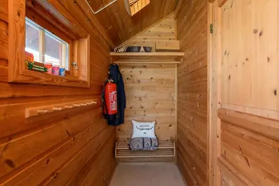a log cabin with a fire extinguisher in a sauna at Nordseter Hytter in Nordseter