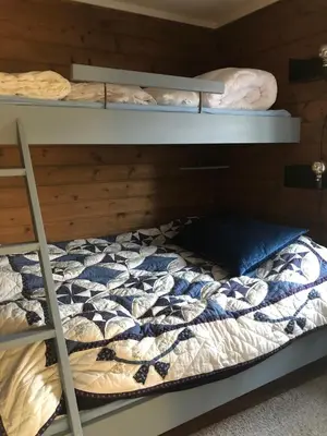 two bunk beds in a room with a bed at Oppdal Alpintun in Oppdal