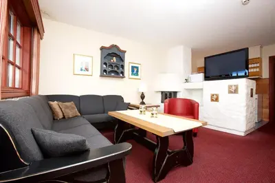 a living room with a couch and a table at Fanitullen Apartments in Hemsedal