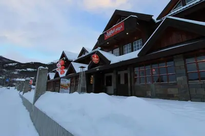 a building with snow in front of it at Fanitullen Apartments in Hemsedal