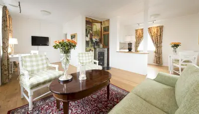 a living room with a couch and a table at Hovde Gård in Brekstad