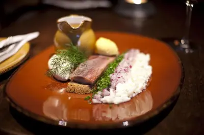 a plate of food with meat and rice on a table at Hovde Gård in Brekstad