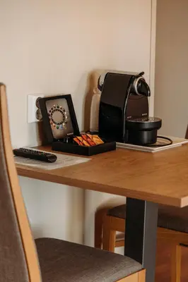 a table with a tea kettle and a clock on it at Solund Leileghetshotell in Hardbakke