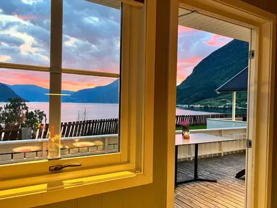 a window view of a lake from a house at Kinsarvik Camping in Kinsarvik