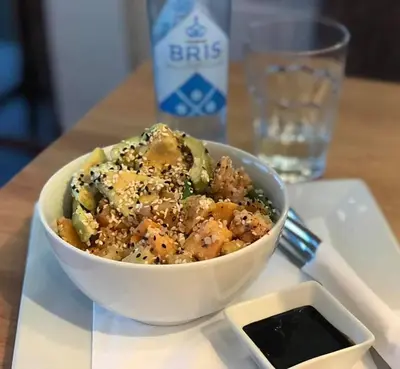 a bowl of food on a table with a drink at Stryn Kaffebar & Vertshus in Stryn