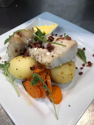 a white plate of food with potatoes and meat at Stryn Kaffebar & Vertshus in Stryn