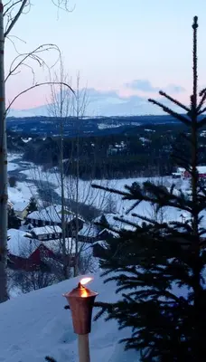 a candle on a pole in the snow at Ivaregga Vinterstua in Tolga