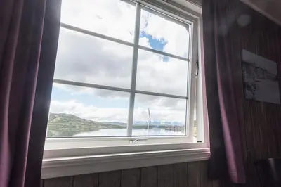 a window with a view of a body of water at Bergsjøstølen Fjellstue in Bergsjostolen