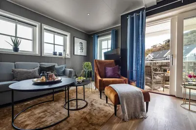 a living room with a couch and a table at Knutholmen in Kalvåg