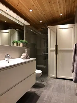 a bathroom with a sink and a shower and a toilet at Svenskveien 23b in Røros