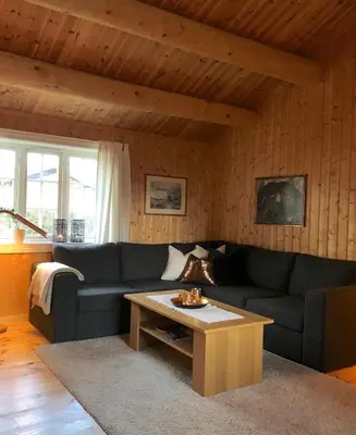 a living room with a couch and a coffee table at Svenskveien 23b in Røros