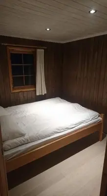 a large bed in a room with a window at Skei Apartments in Svingvoll