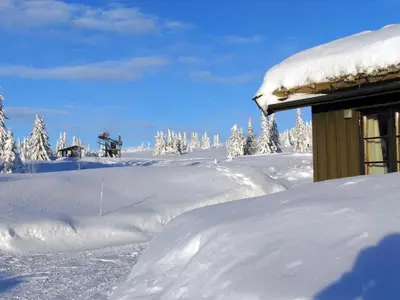 a snow covered roof of a house with a snow covered yard at Skei Apartments in Svingvoll