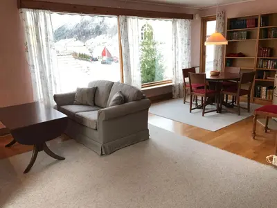 a living room with a couch and a table at Villa Holmen 2 in Balestrand