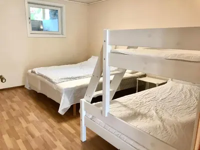 a room with two bunk beds and a window at Villa Holmen, ground floor apartment in Balestrand
