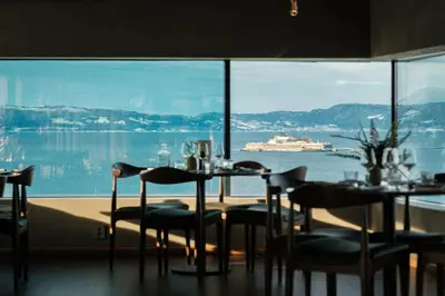 a dining room with a view of a cruise ship at Clarion Hotel Trondheim in Trondheim