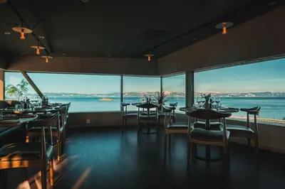 a restaurant with tables and chairs and large windows at Clarion Hotel Trondheim in Trondheim