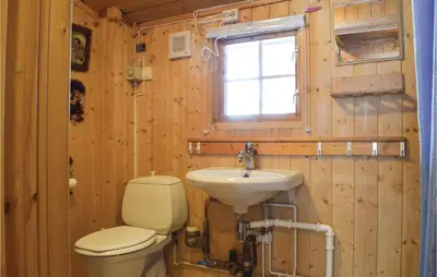 a bathroom with a toilet and a sink at Stunning Home In Sjusjøen With Kitchen in Sjusjøen