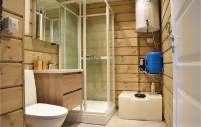 a bathroom with a shower and a toilet and a sink at Cozy Home In Sjusjøen With Kitchen in Sjusjøen