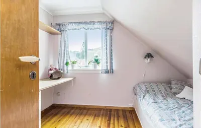 a bedroom with a bed and a window at 5 Bedroom Lovely Home In Seim in Seim