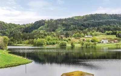 a large lake in front of a mountain at 5 Bedroom Lovely Home In Seim in Seim