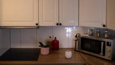 a kitchen counter with a microwave on a table at Fjellhagen in Bjørkheim
