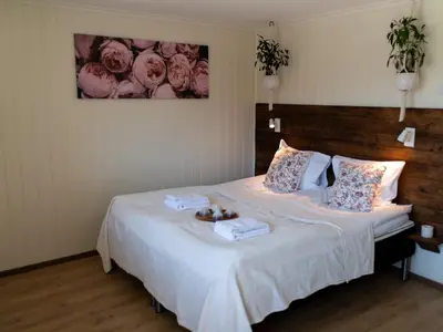 a bedroom with a large bed with two boxes on it at Fjellhagen in Bjørkheim