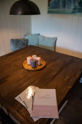 a wooden table with two candles on a tray at Fjellhagen in Bjørkheim