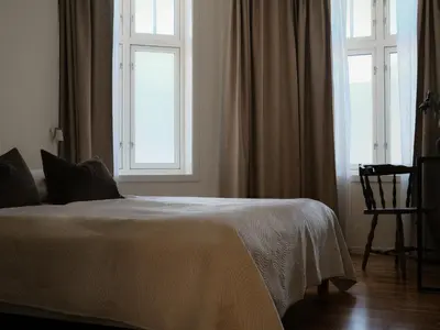a bedroom with a bed and a window at Blue House Odda in Odda
