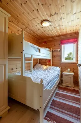 a bedroom with a bunk bed in a log cabin at Valley View in Stranda