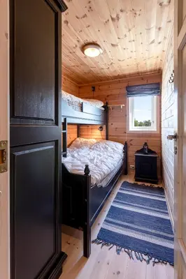 a bedroom with a bed in a wooden cabin at Valley View in Stranda