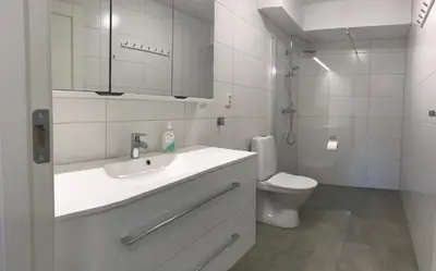 a white bathroom with a sink and a toilet at Haukelifjell Skisenter in Vågsli