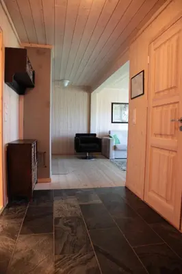 a living room with a door and a couch at Haukelifjell Skisenter in Vågsli